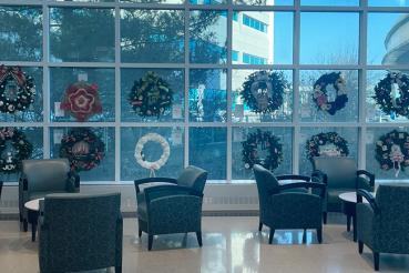 Multiple wreaths decorate windows in RUSH Copley Medical Center's Main Lobby during the Festival of Giving Wreaths.