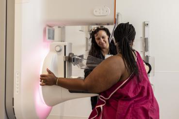 A medical professional guides someone through a medical process.
