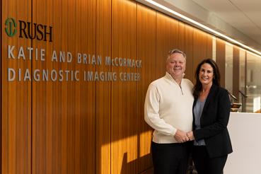 Katie and Brian McCormack stand together next to a sign for the Katie and Brian McCormack Diagnostic Imaging Center at RUSH.
