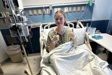 Madison Moore gives a thumbs up while in the hospital 