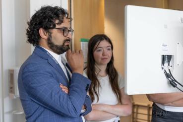 Arka Mallela, MD, MS, assistant professor, Department of Neurological Surgery, and Jackie Bollinger use the MindTrace system to assess a patient.
