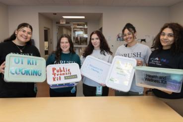 Occupational Therapy students pose with their occupation kits created for Rush Specialty Hospital.