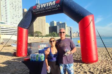 Tom Boucher and Melinda Remaly stand on Ohio Street Beach for a previous Swim Across America Chicago Open Water Swim.
