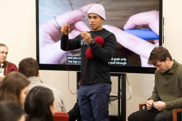 JP Arios teaches students how to crochet