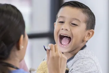 Boy saying 'aaah' at doctor's office