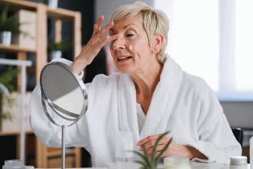 Woman applying moisturizer to her face