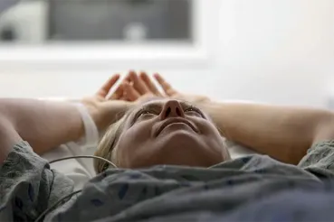 A patient lies back as she gets a heart CT scan.