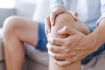 Man holding his knee