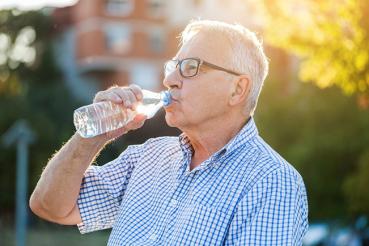 Older man drinks water