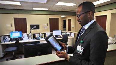 Dr. Akoh reviewing image on tablet