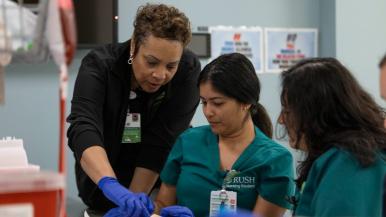 Nursing students practice IV insertion.