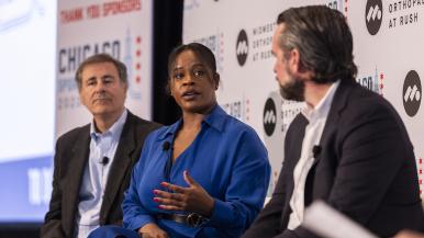 Three panelists talk during a prior year's Chicago Sports Summit.