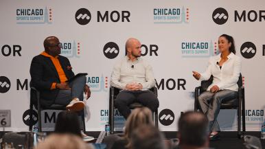 Three seated individuals have a discussion at the 2025 Chicago Sports Summit.