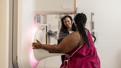 A medical professional guides someone through a medical process.
