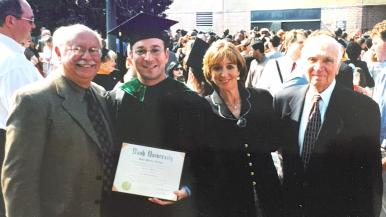 Dr. Eric Feldman stands at commencement with his family.