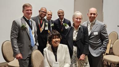 Fall RUSH Investiture Ceremony honorees pose for a photo with Michelle and Larry Goodman, MD.