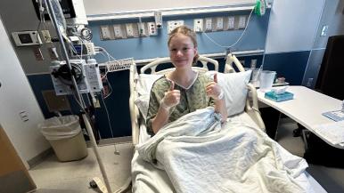 Madison Moore gives a thumbs up while in the hospital 