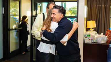 Omar Ramos hugs a participant at Waterford Place