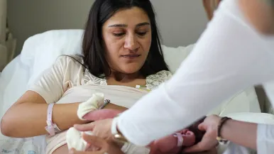 Woman in hospital breastfeeding baby