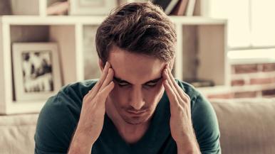 Man with headache holding head