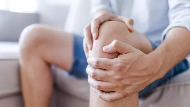 Man holding his knee