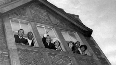 Martin Luther King Jr. waves from the window of his apartment in Chicago