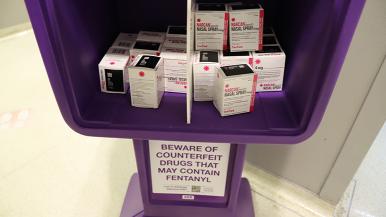 purple newsstand with boxes of narcan inside