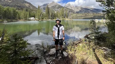Reese Storr with lake and mountains in background