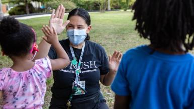 Rush social worker at a school-based health center event