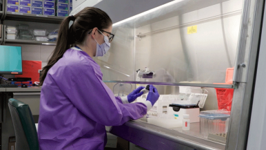A scientist prepares samples for genomic sequencing