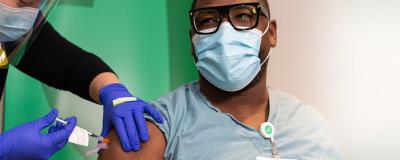 Rush health care worker receiving a COVID-19 vaccine