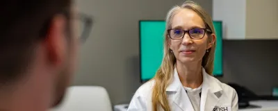 Nancy Reau MD listening to a patient's concerns.