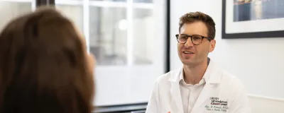 Grunvald MD chatting with patient.