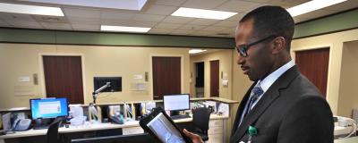 Dr. Craig C. Akoh viewing image on tablet