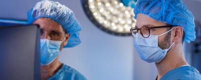 RUSH neurosurgeons and brain tumor specialists Richard Byrne, MD, and Stephan Munich, MD, performing surgery.