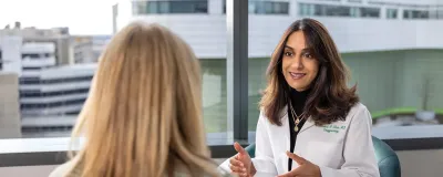 Fareesa Khan, MD, MS-HSM, speaking with a patient