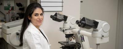 Mariam Mafee, MD, at a microscope