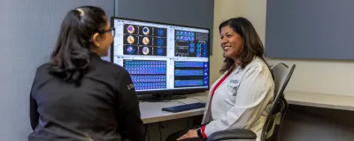Rush cardiologist discussing lab results with lab images on screen