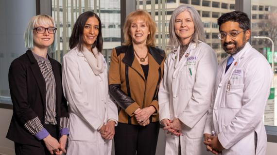 Rita Dragonette, center, poses with RUSH doctors