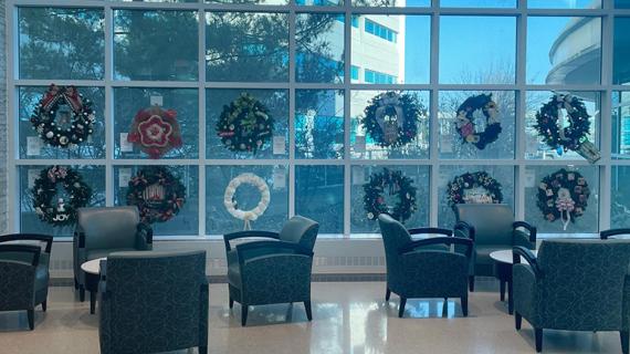 A dozen wreaths hang in the windows of RUSH Copley Medical Center.