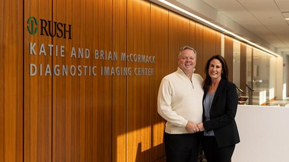 Katie and Brian McCormack stand together next to a sign for the Katie and Brian McCormack Diagnostic Imaging Center at RUSH.