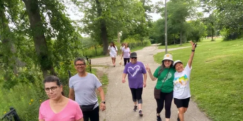 A group of people walking through a park