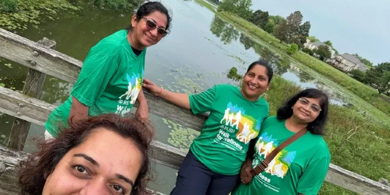 Group selfie outdoors on a footbridge