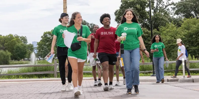 A group of smiling people crosses a street